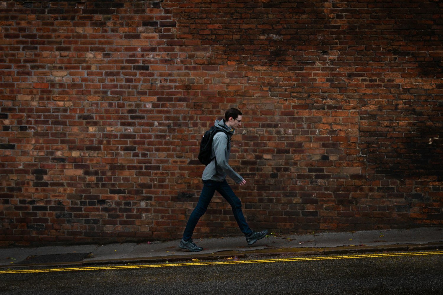 A person walking alone along a city sidewalk