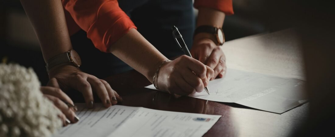 A person writing a statement on paper, as when drafting a buddy letter for a VA claim