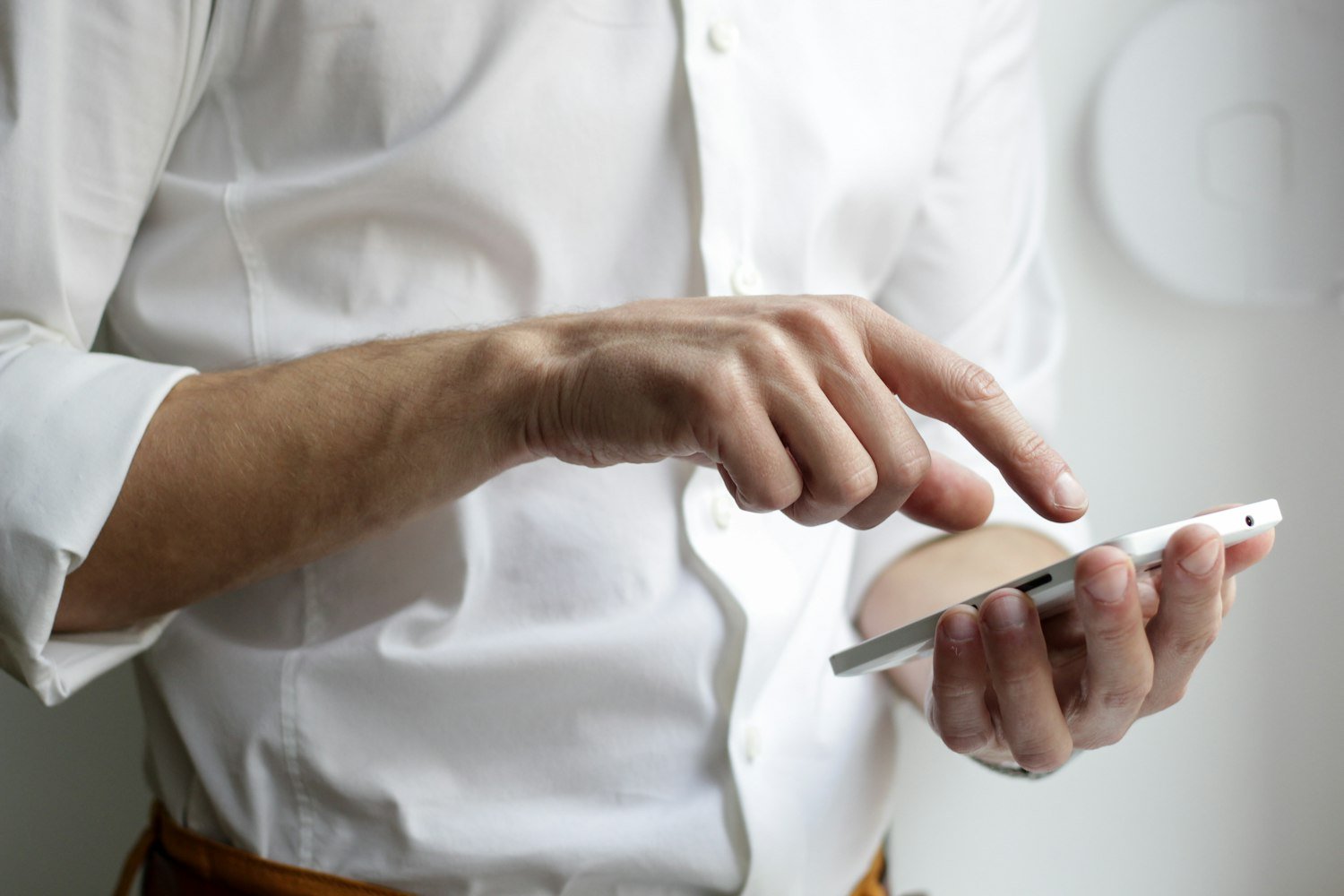 A person holding a smartphone, representing a Buddy Check phone call to a fellow veteran