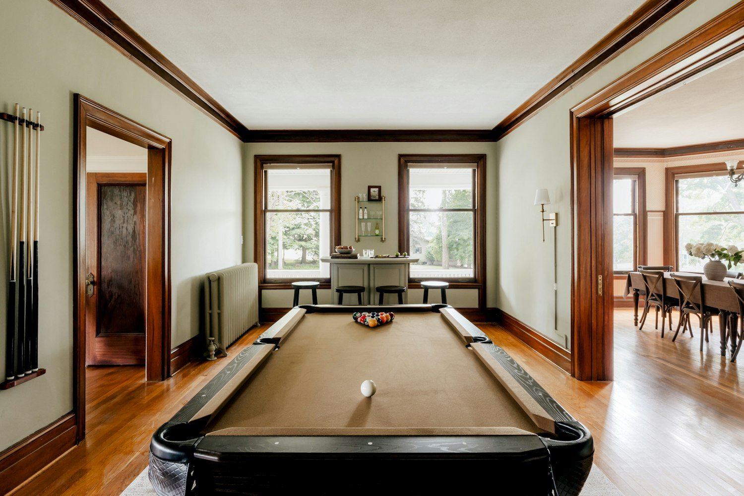A pool table in a large room with wooden floors, a common feature of veteran post club rooms