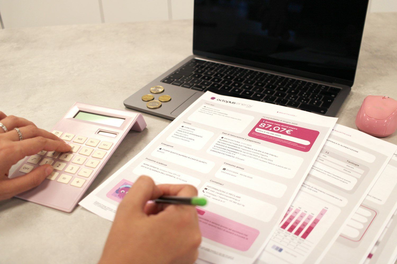 Someone reviewing household finances with documents and a calculator