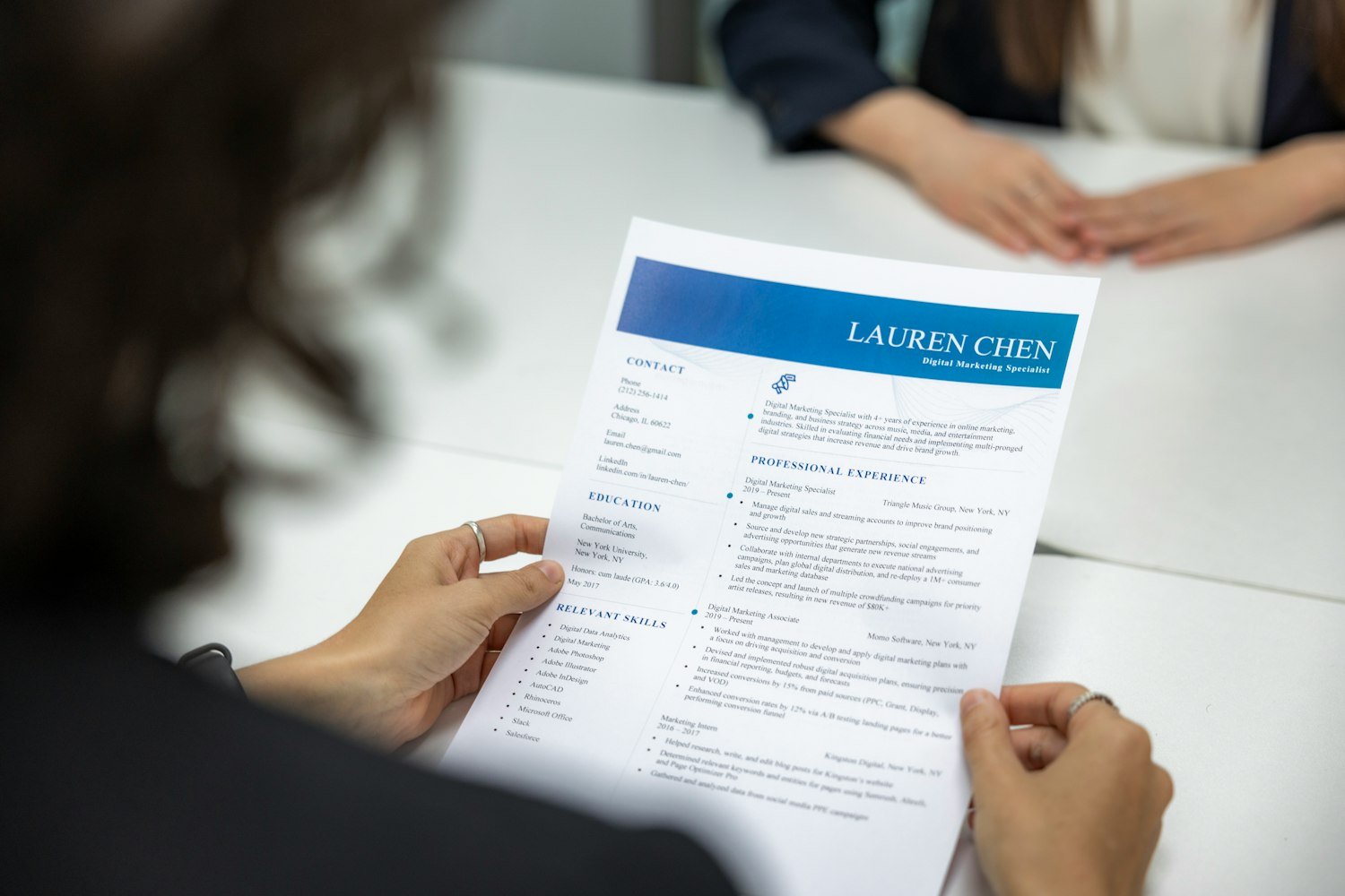 A person reading a resume at a table, reflecting the work history TDIU claims require