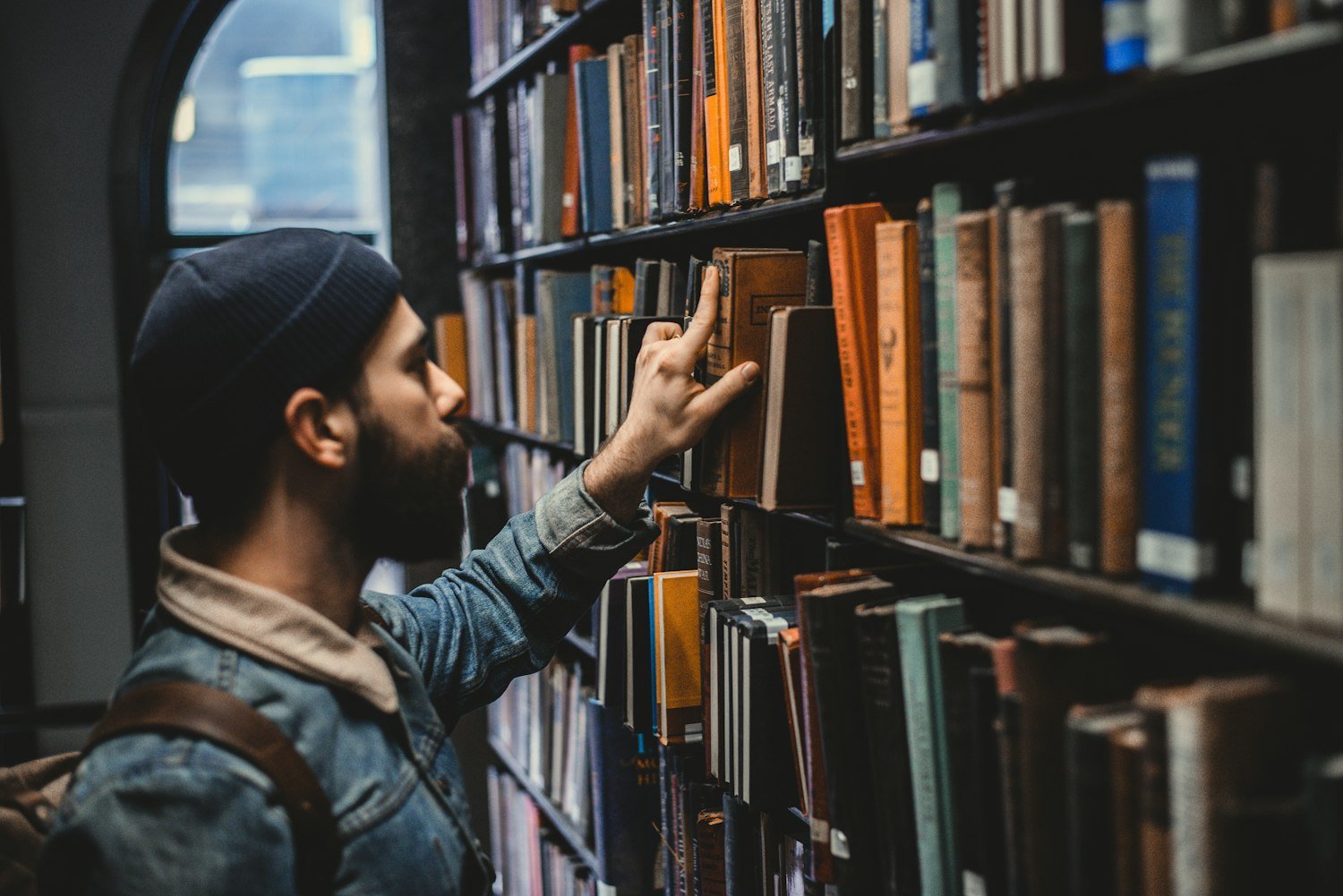 A person searching shelves for a document, as archivists do when reconstructing service records
