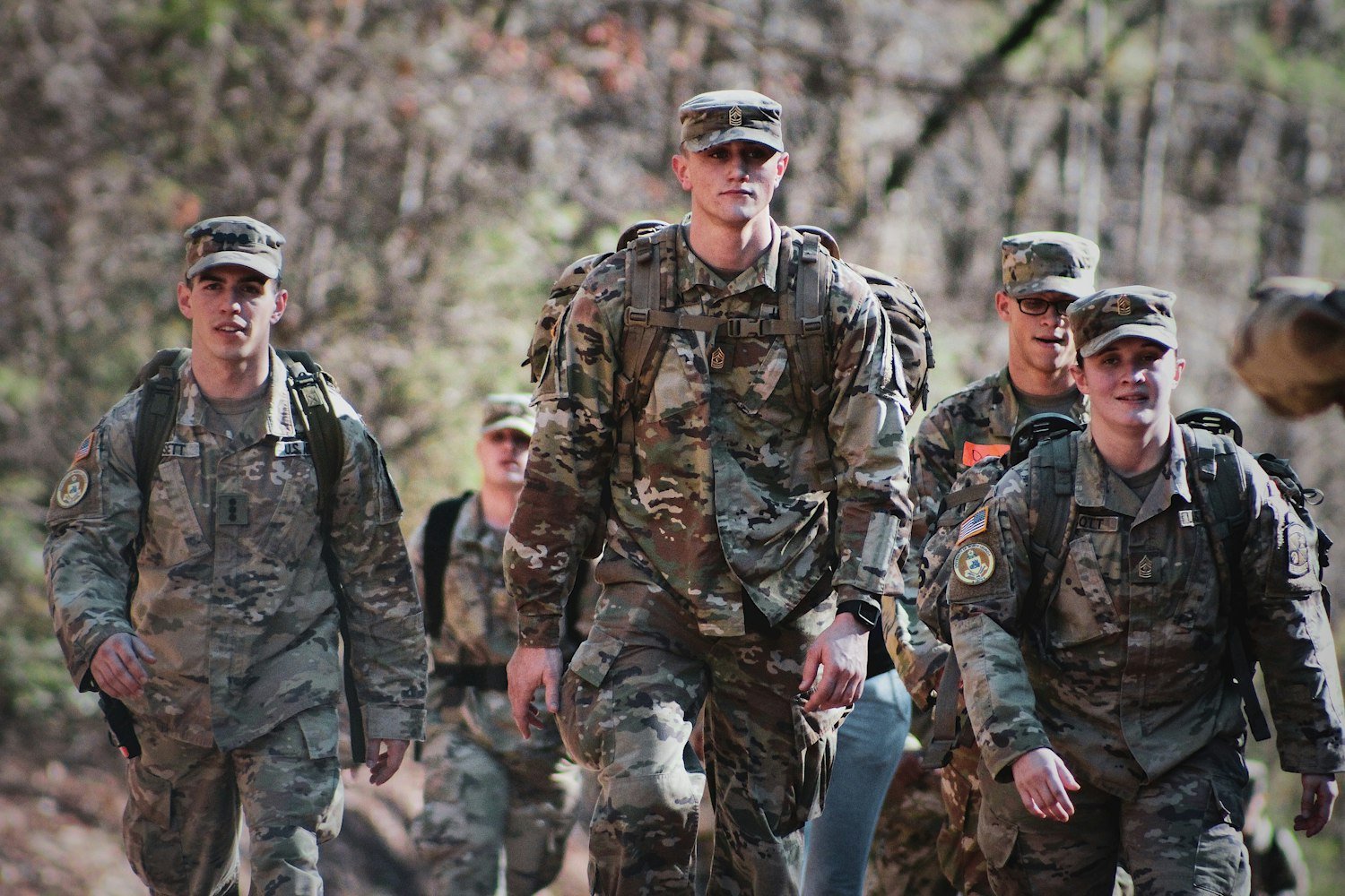 Service members in uniform standing in formation on a field, reflecting the National Security pillar