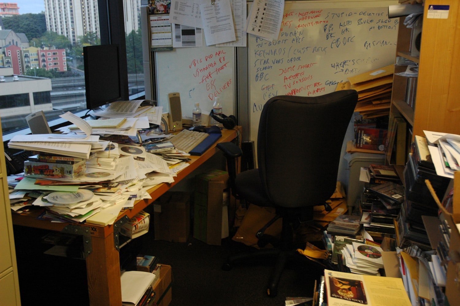 A stack of paperwork on an office table, representing certification documents