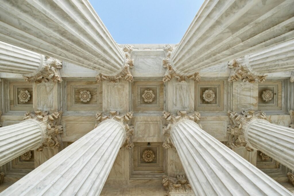 Stone columns of a courthouse seen from below