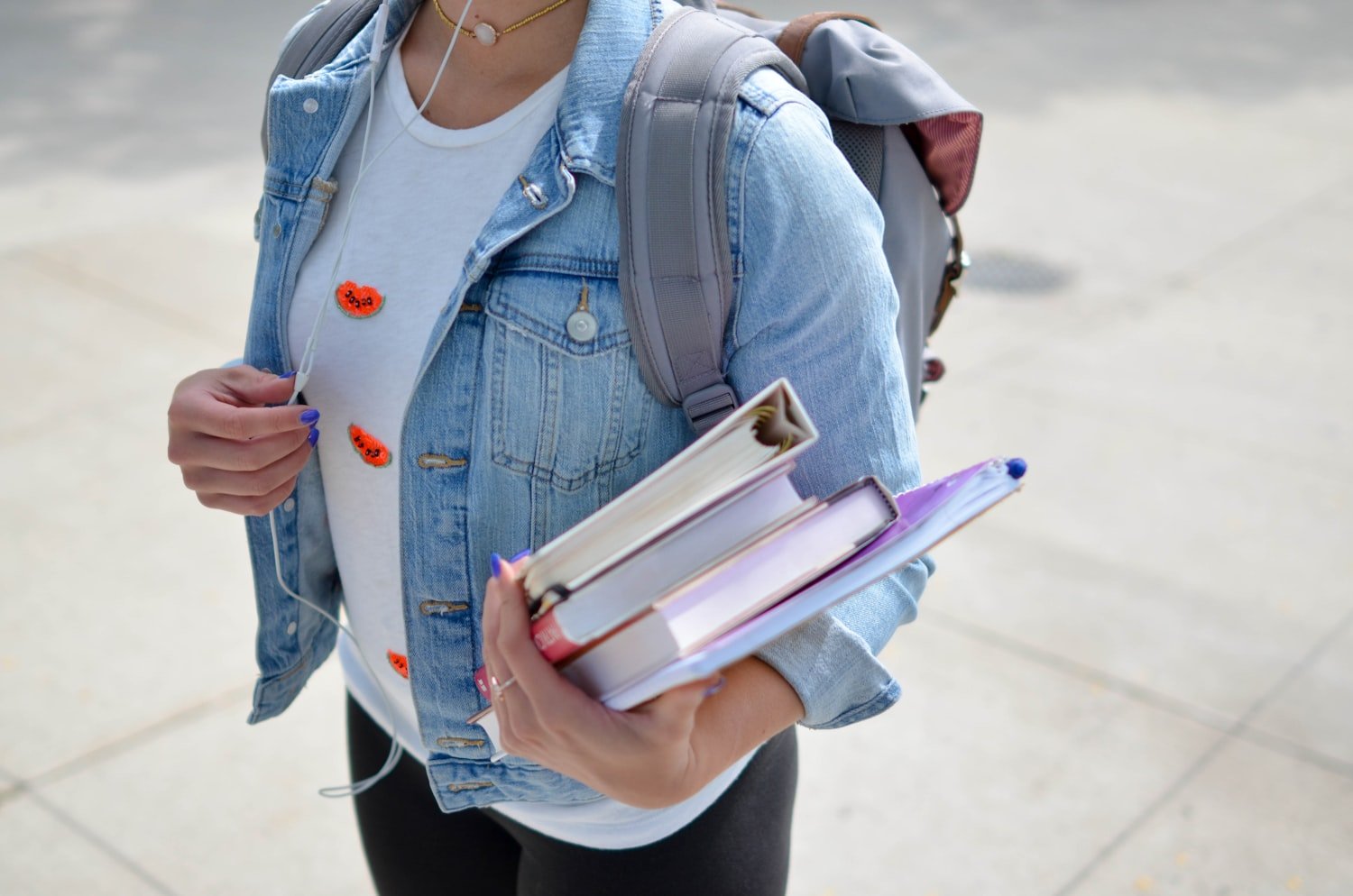 A student holding a textbook, representing the GI Bill books and supplies stipend
