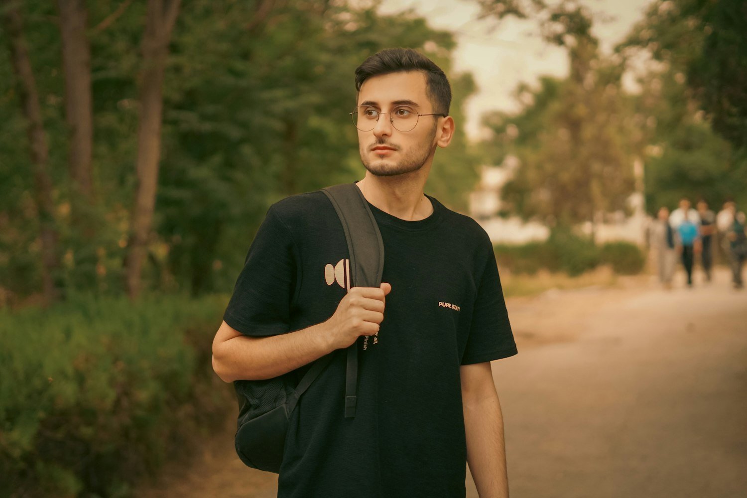 A student with a backpack walking outdoors, since children 18 to 23 in school can remain dependents