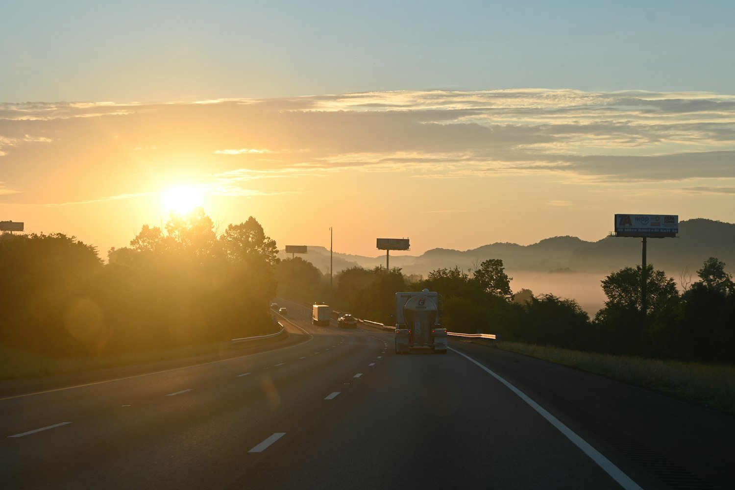 Sunrise over a highway with distant mountains, an early drive to a VA medical center