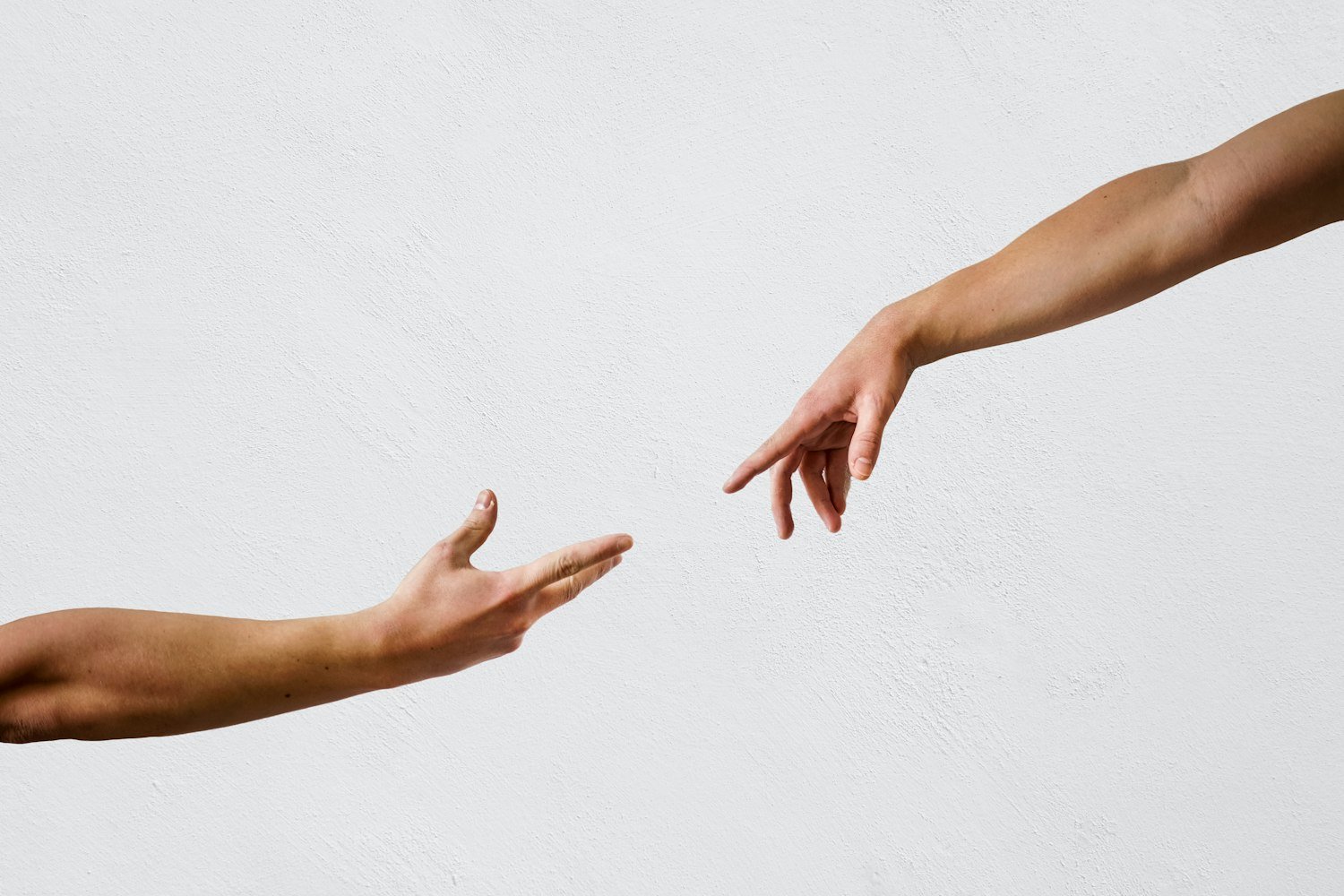 Two hands reaching toward each other, representing offered support