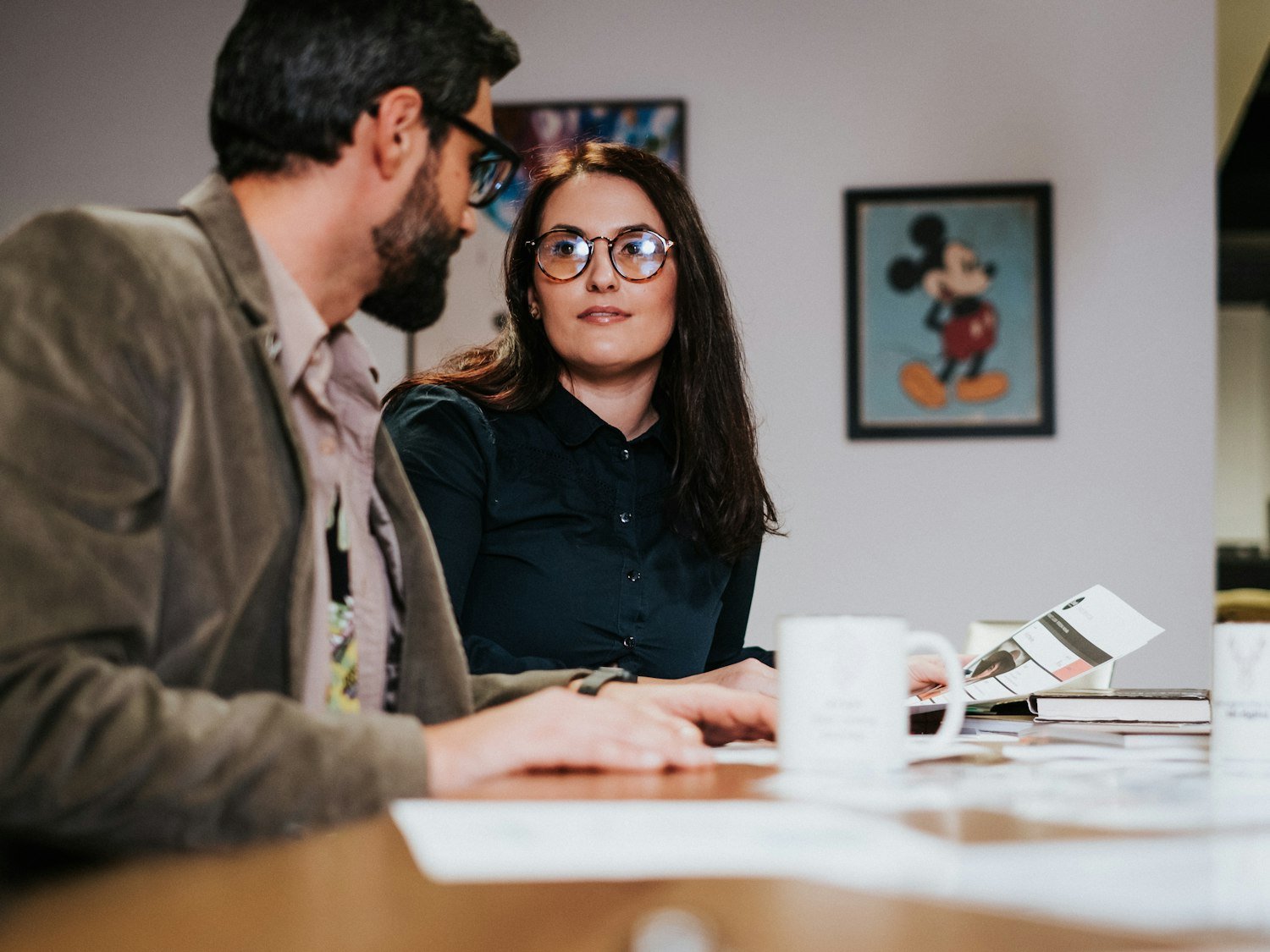 Two people meeting across a table, as in a free small business counseling session