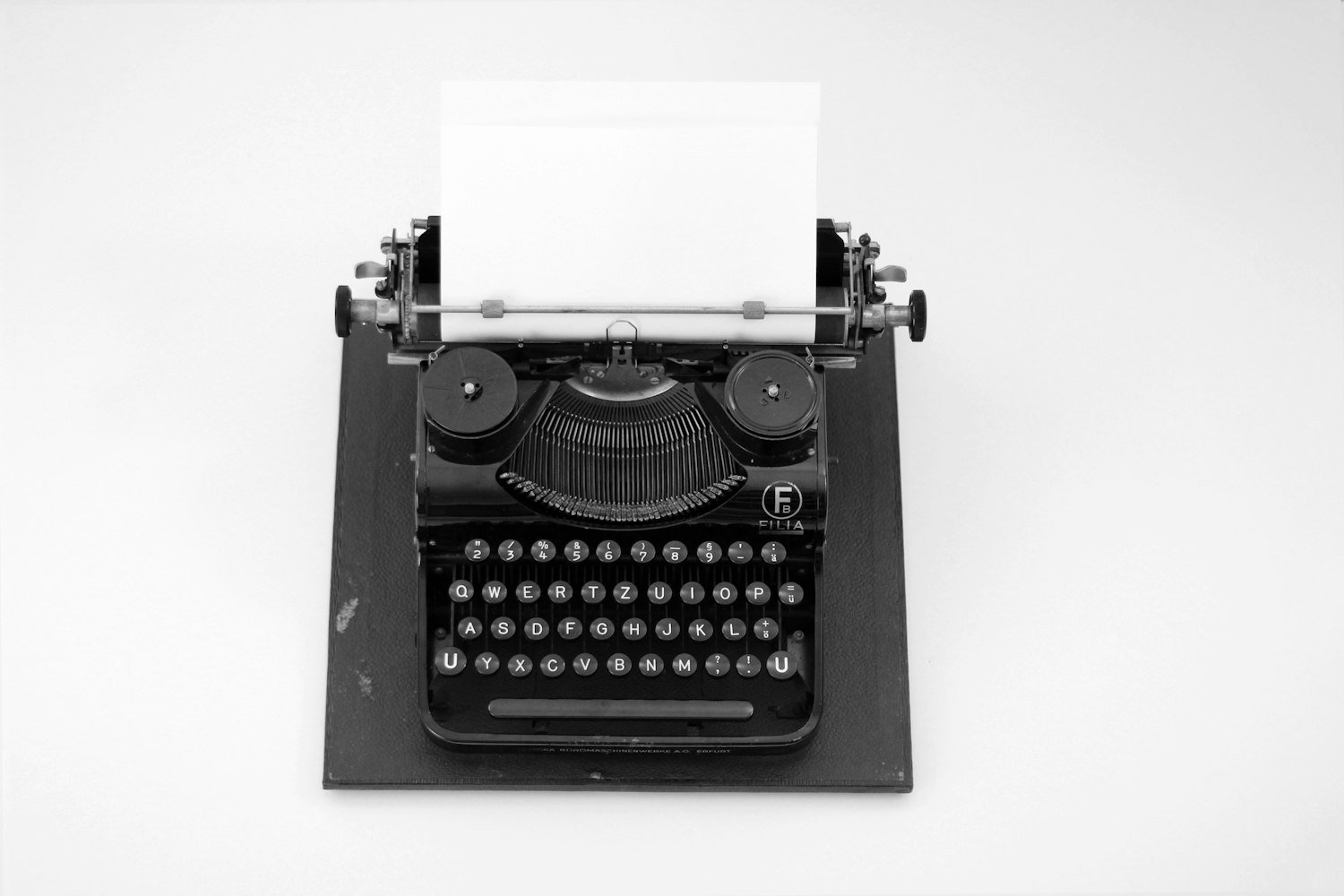A typewriter with a blank page, representing the blank-page problem of starting a statement