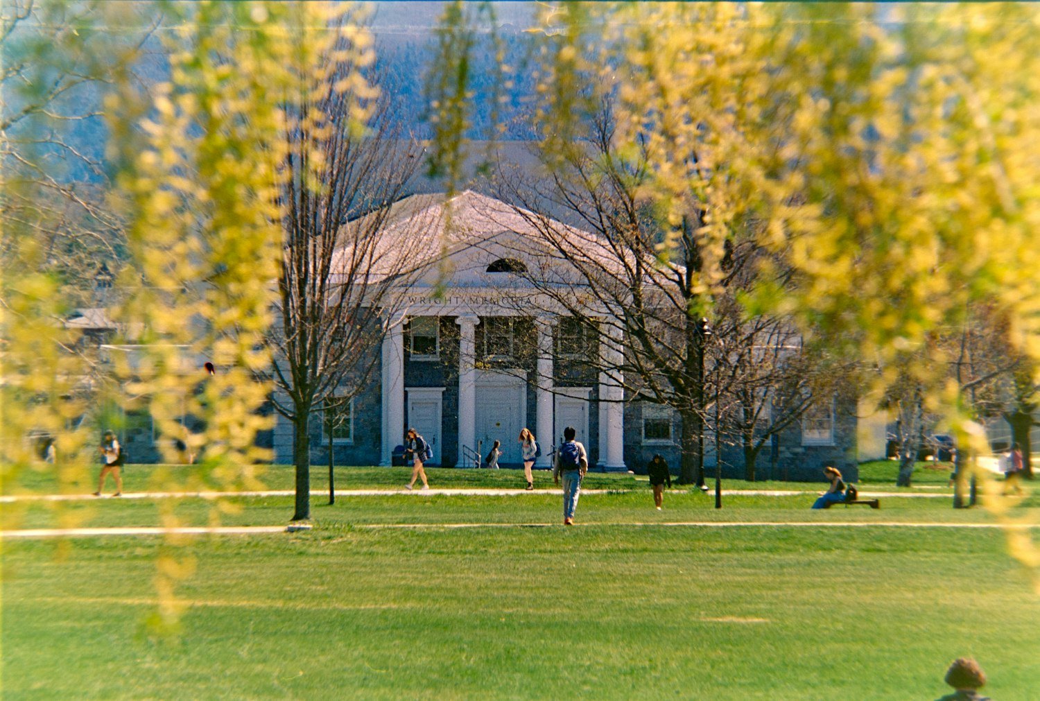 A columned university building on a grassy campus