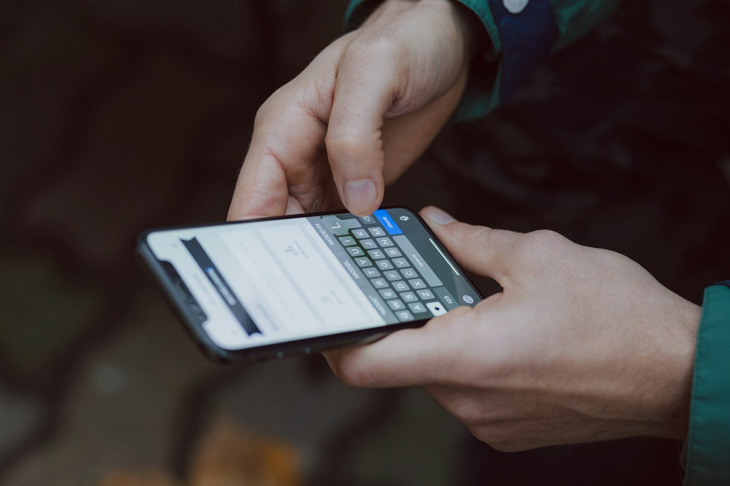 A person using a smartphone, as when starting and saving a VA application online