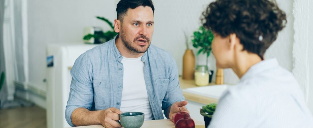 Two people sitting across a table discussing paperwork, like a veteran meeting with a service officer