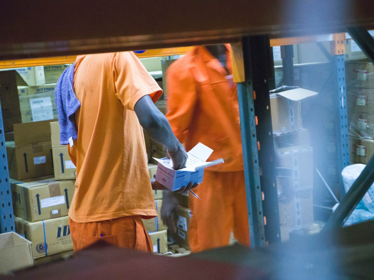 A warehouse worker carrying a box, the kind of physical work a disability can end
