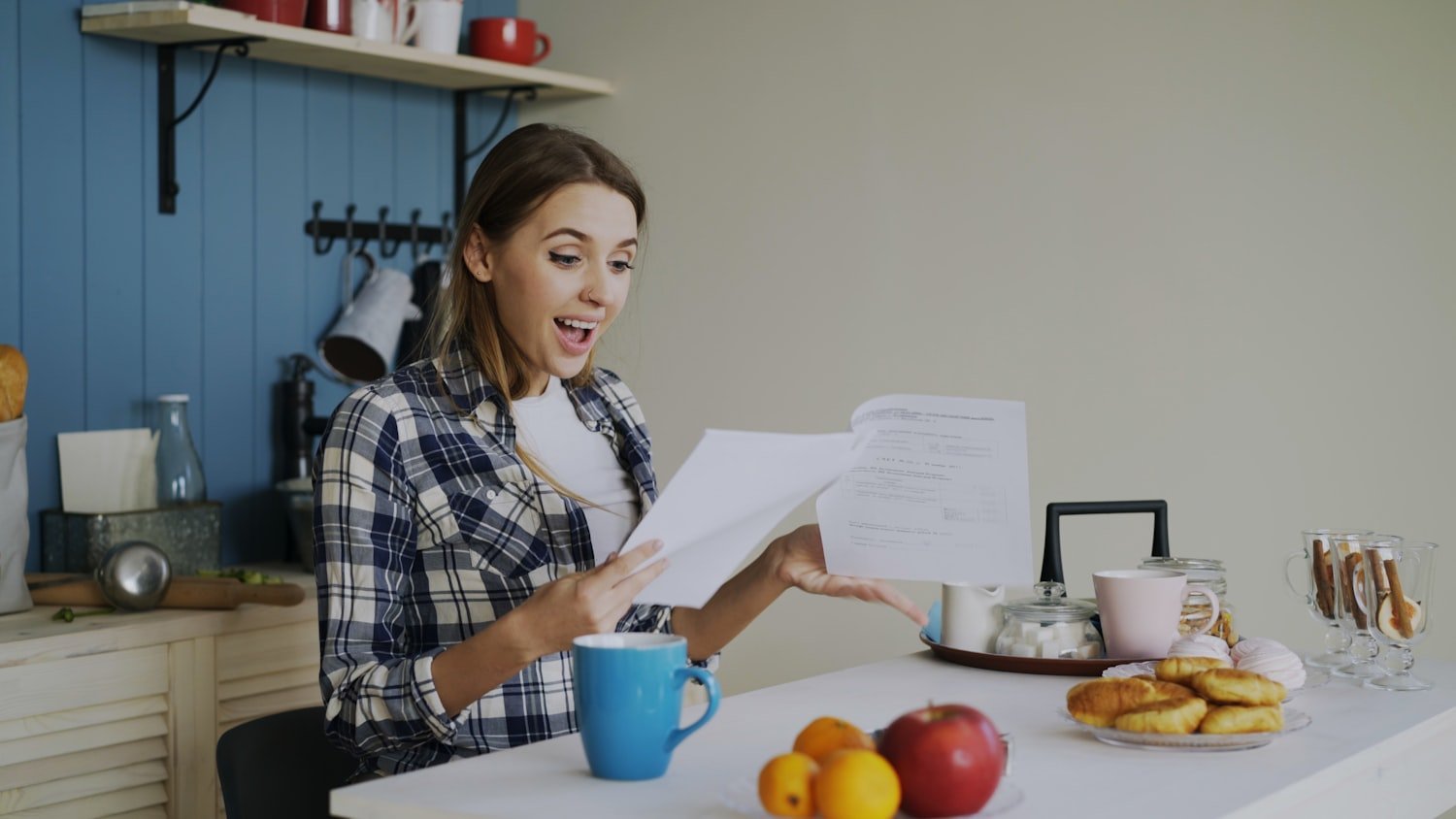 A woman reading documents at a table, as when reviewing survivor benefit paperwork