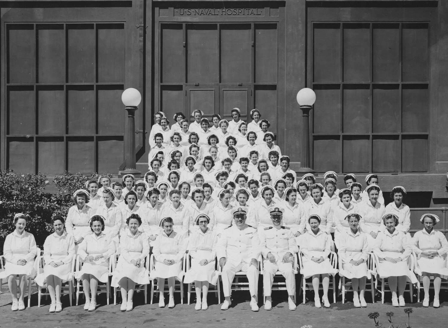 A group of women in service uniform standing together outside a building