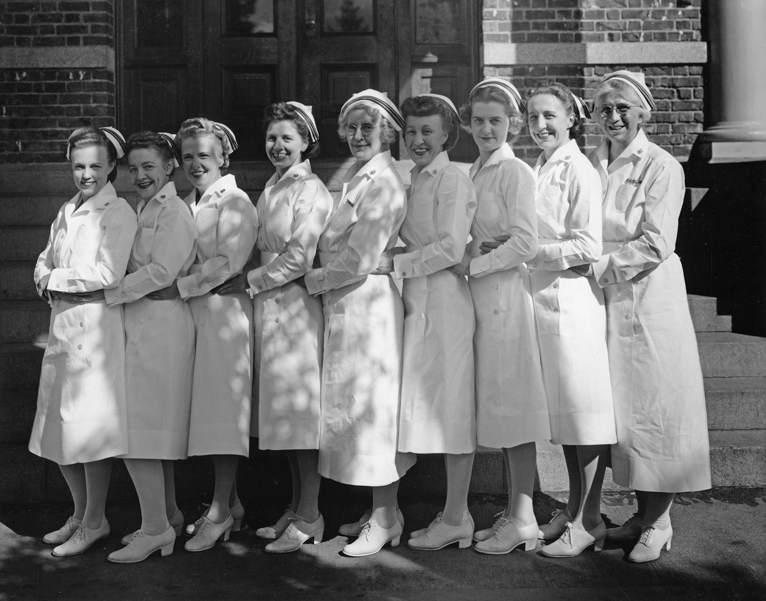 A group of nurses in uniform standing together, representing the women veterans who were delegates at the Legion's first convention