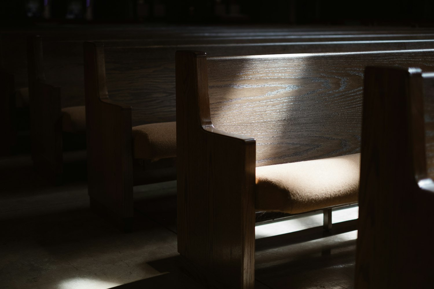 A wooden chapel chair, representing quiet seating at a funeral service