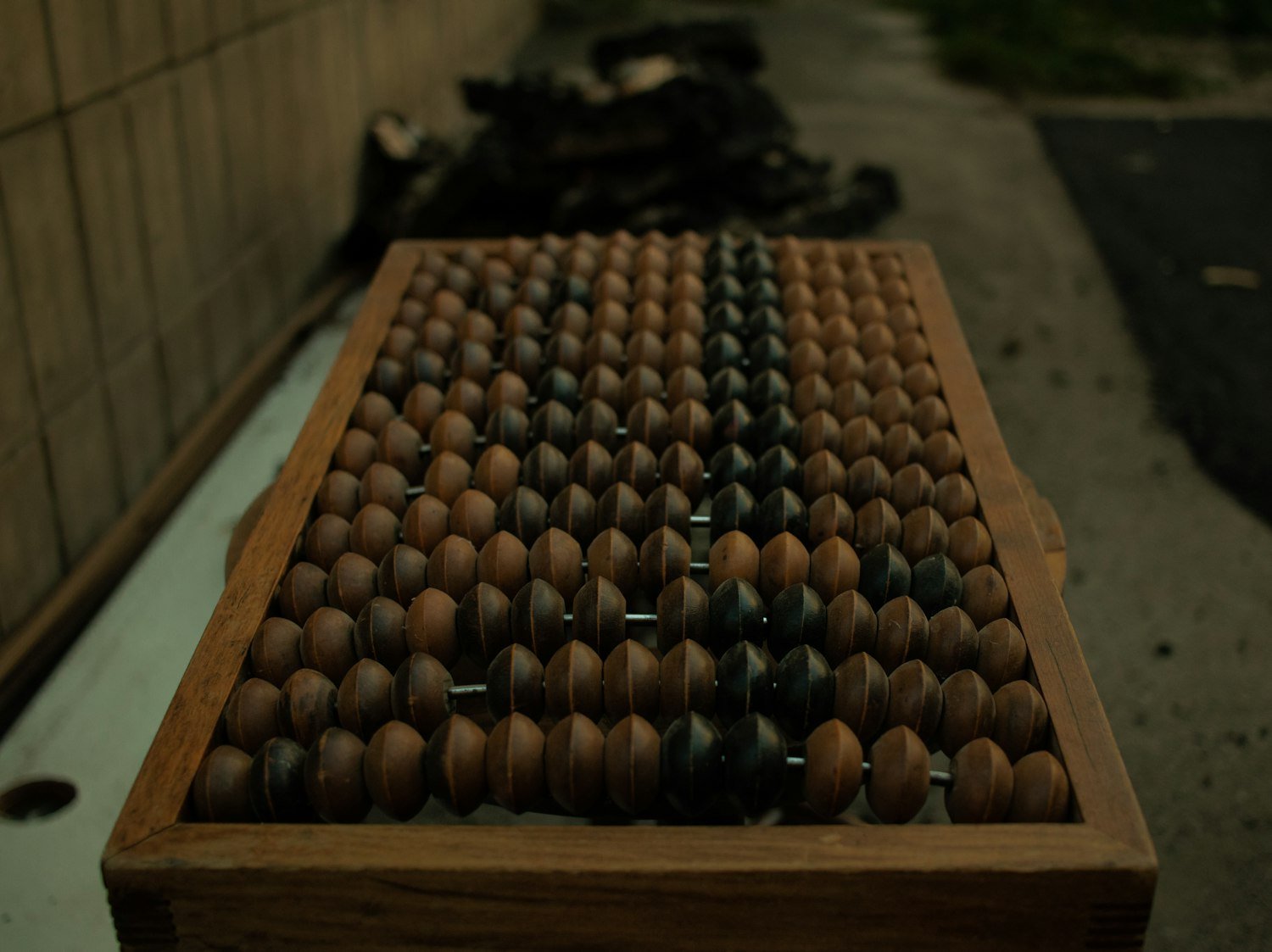 Wooden counting pieces in a box, evoking step-by-step calculation