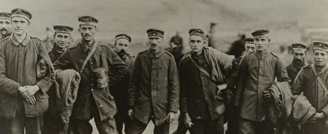 A vintage grayscale photograph of a group of World War I soldiers in uniform